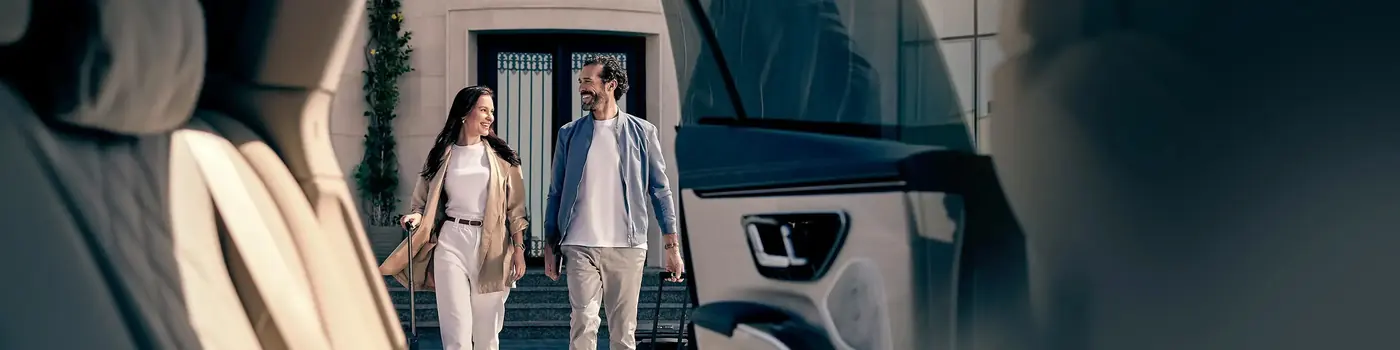 Film Unit Car chauffeur beside an executive vehicle at a UK production gate